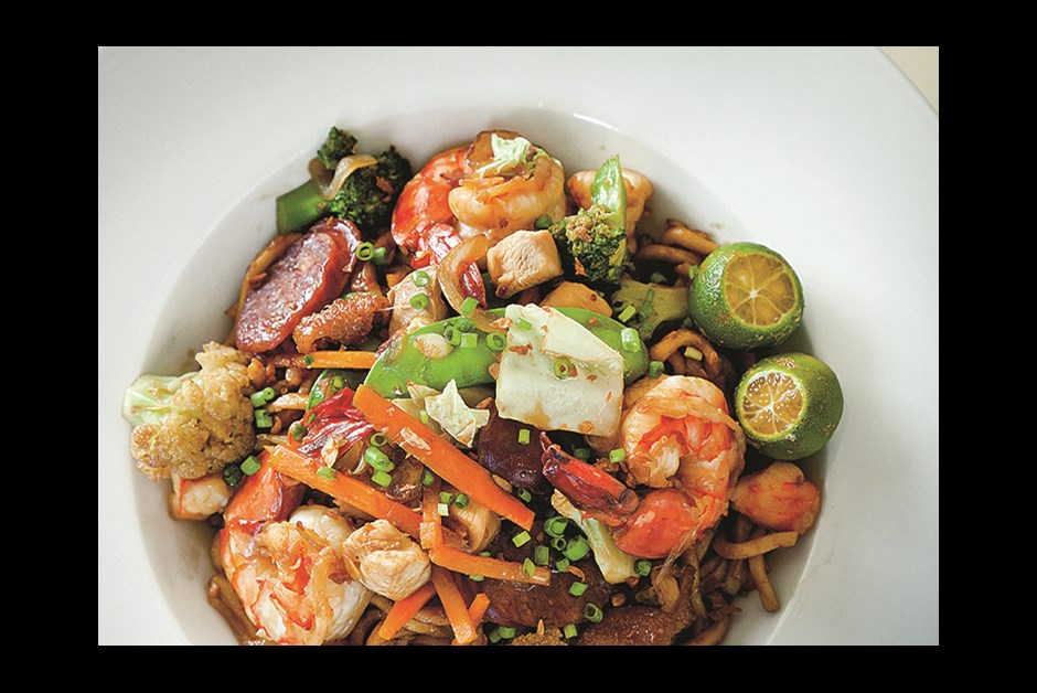 COLORFUL PANCIT GUISADO IS A CHINESE-INSPIRED DISH OF PRAWNS, PORK BELLY AND CHICKEN OVER EGG NOODLES